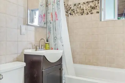 a bathroom with a sink and a shower curtain at Pacific Sunrise in San Diego