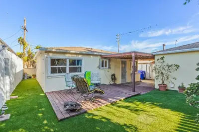 a backyard with a wooden deck with a table and chairs at Pacific Sunrise in San Diego