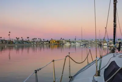 a boat docked in a marina at sunset at 1000#1 Contemporary Home w/ Parking, Grill, & AC! in Newport Beach