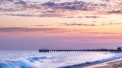 a beach with a pier in the ocean with a sunset at 1000#1 Contemporary Home w/ Parking, Grill, & AC! in Newport Beach