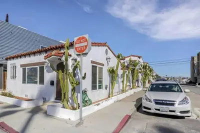 a car parked in front of a building with a stop sign at 1000#2 Magnificent Beach Home w/ AC & 4K TVs in Newport Beach