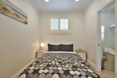 a bedroom with a bed and two windows at 1000#3 Renovated Home by Beach & Sand - AC & More! in Newport Beach