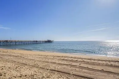 a view of a beach with a pier in the water at 1000#3 Renovated Home by Beach & Sand - AC & More! in Newport Beach