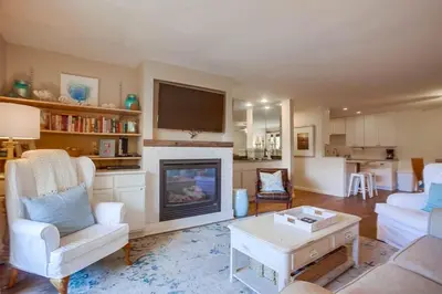 a living room with a fireplace and a tv at Coastal Chic Style Condo SBTC 128 in Solana Beach
