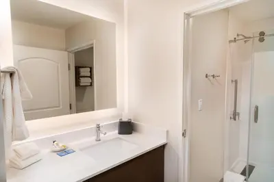 a white bathroom with a sink and a mirror at Staybridge Suites - Temecula - Wine Country by IHG in Temecula