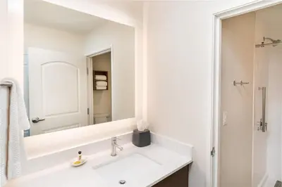 a white bathroom with a sink and a mirror at Staybridge Suites - Temecula - Wine Country by IHG in Temecula