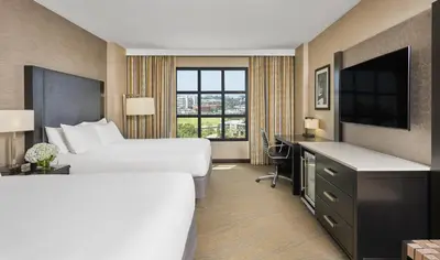 a hotel room with a large bed and a desk at Hyatt Regency La Jolla at Aventine in San Diego