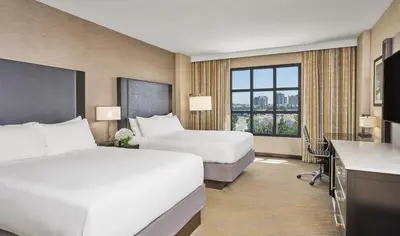 a hotel room with two beds and a desk at Hyatt Regency La Jolla at Aventine in San Diego