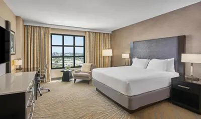 a hotel room with a bed and a chair at Hyatt Regency La Jolla at Aventine in San Diego