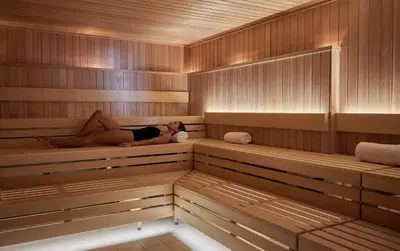 a woman is laying in a sauna at Mission Pacific Beach Resort, part of JdV by Hyatt in Oceanside