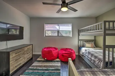 a bedroom with a bed and a bunk bed at Spacious El Cajon Villa - 14 Mi to Downtown! in El Cajon
