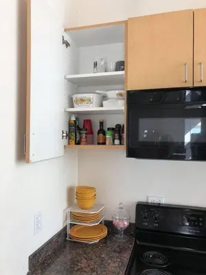 a kitchen with a stove and a microwave at Beautiful new detached casita nestled in scenic southern CA foothills! in Fallbrook