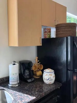 a kitchen with a black refrigerator and a counter top at Beautiful new detached casita nestled in scenic southern CA foothills! in Fallbrook