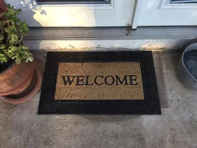 a welcome mat in front of a door with the word welcome at Beautiful new detached casita nestled in scenic southern CA foothills! in Fallbrook