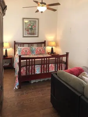 a bedroom with a bed and two lamps and a couch at Beautiful new detached casita nestled in scenic southern CA foothills! in Fallbrook