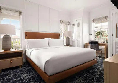 a bedroom with a large bed and a desk at Beach Village at The Del, LXR Hotels & Resorts in San Diego