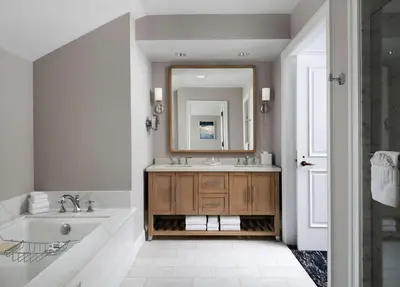 a bathroom with a tub and a sink and a mirror at Beach Village at The Del, LXR Hotels & Resorts in San Diego