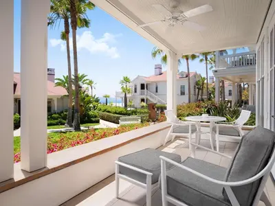 a patio with chairs and a table on a porch at Beach Village at The Del, LXR Hotels & Resorts in San Diego