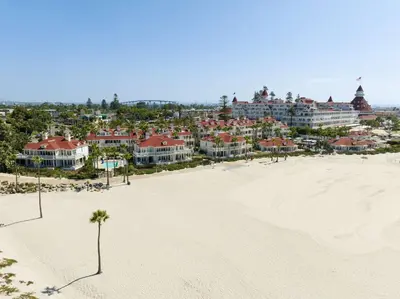 a view of a beach with a resort in the background at Beach Village at The Del, LXR Hotels & Resorts in San Diego