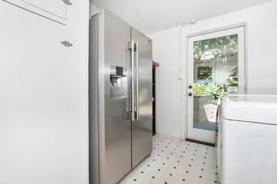 a kitchen with a pivot door and a sink at 26' SUNDECK OCEAN Panoramic VIEWS with AC Fast WiFi -902Mbps in San Diego