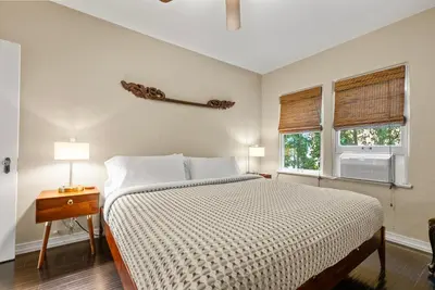 a bedroom with a large bed and two windows at 26' SUNDECK OCEAN Panoramic VIEWS with AC Fast WiFi -902Mbps in San Diego