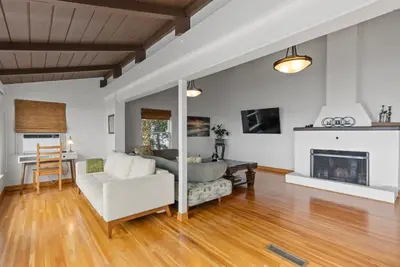 a living room with a couch and a fireplace at 26' SUNDECK OCEAN Panoramic VIEWS with AC Fast WiFi -902Mbps in San Diego