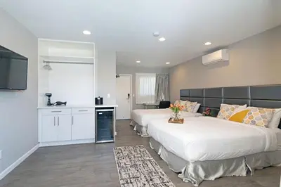 a large room with two beds and a kitchen at Sands Of La Jolla in San Diego