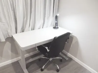 a white desk with a black chair in front of a window at Sands Of La Jolla in San Diego