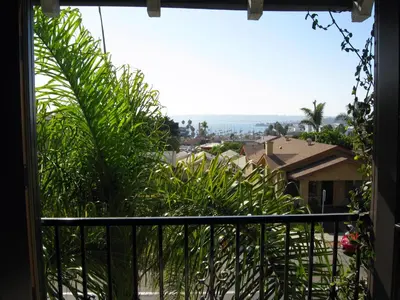 a view from the balcony of a house with plants at RK Hostel in San Diego
