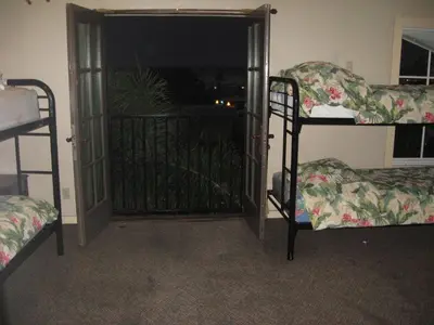 a room with two bunk beds and an open door at RK Hostel in San Diego