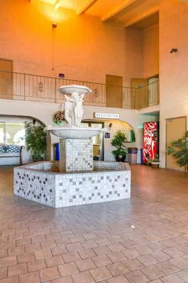 a fountain in the middle of a lobby at California Suites Hotel in San Diego