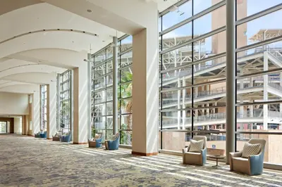 an empty lobby with chairs and windows at Omni San Diego Hotel at the Ballpark in San Diego