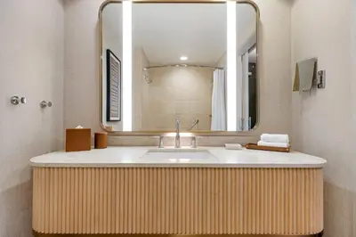 a bathroom with a sink and a large mirror at Omni San Diego Hotel at the Ballpark in San Diego