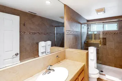 a bathroom with a sink and a toilet at Luxury Oceanfront Home - Lower in Oceanside