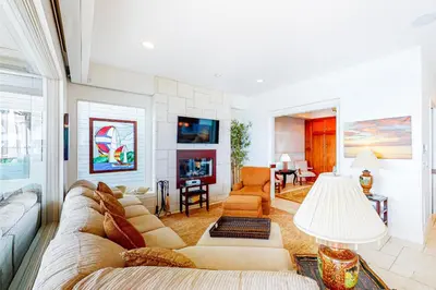 a living room with a couch and a fireplace at Luxury Oceanfront Home - Lower in Oceanside