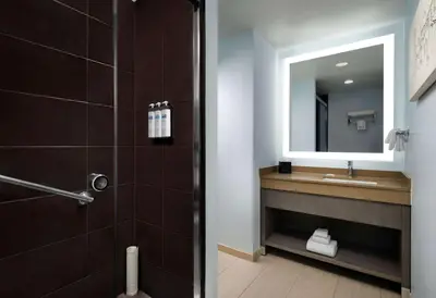 a bathroom with a sink and a mirror at Hyatt House San Diego Sorrento Mesa in Sorrento