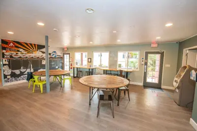a room with two tables and chairs in it at California Dreams Hostel - Ocean Beach in San Diego