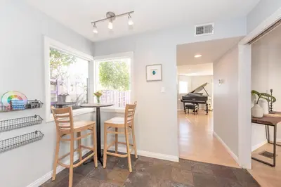 a kitchen and dining room with a table and chairs at Beach Resort Home with Ocean Views Jacuzzi & Sauna! in San Diego