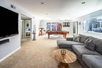 a living room with a couch and a table at Beach Resort Home with Ocean Views Jacuzzi & Sauna! in San Diego