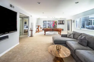 a living room with a couch and a table at Beach Resort Home with Ocean Views Jacuzzi & Sauna! in San Diego