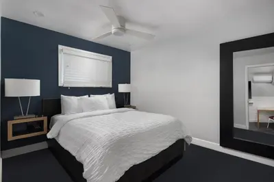 a bedroom with a bed and a blue wall at Beach Haven in San Diego
