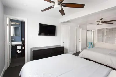 a bedroom with a bed and a ceiling fan at Beach Haven in San Diego