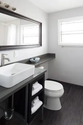 a bathroom with a sink and a toilet and a mirror at Beach Haven in San Diego
