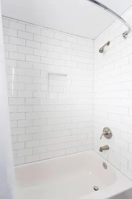 a white bathroom with a tub and a sink at Beach Haven in San Diego