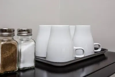 a tray with three glass jars and some spices at Comfy Studio with Cali King Size Mattress in San Diego