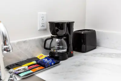 a coffee maker sitting on a kitchen counter next to a sink at Centrally Located Cozy Studio Apartment in SD in San Diego