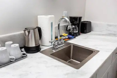 a kitchen counter with a sink and a coffee maker at Centrally Located Cozy Studio Apartment in SD in San Diego