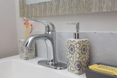a kitchen sink with two faucets and a soap dispenser at Centrally Located Cozy Studio Apartment in SD in San Diego