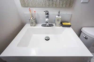 a white sink in a bathroom with a toilet at Centrally Located Cozy Studio Apartment in SD in San Diego