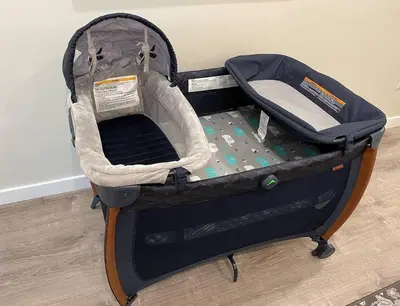 a baby car seat in a suitcase on the floor at Centrally Located Cozy Studio Apartment in SD in San Diego